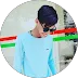  Young man in a light blue shirt and sunglasses wearing a dark beanie
